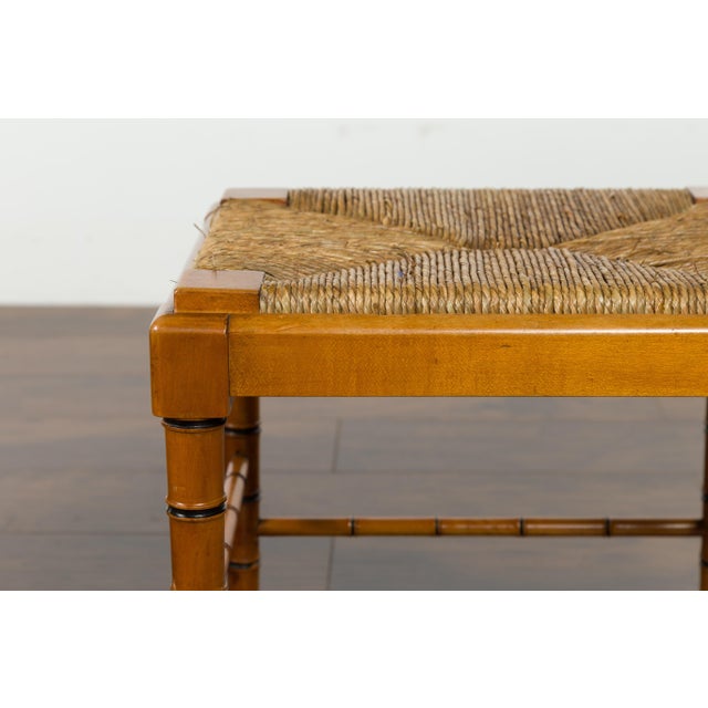 A pair of English vintage walnut stools from the mid-20th century, with faux bamboo bases and rush seats. Created in...