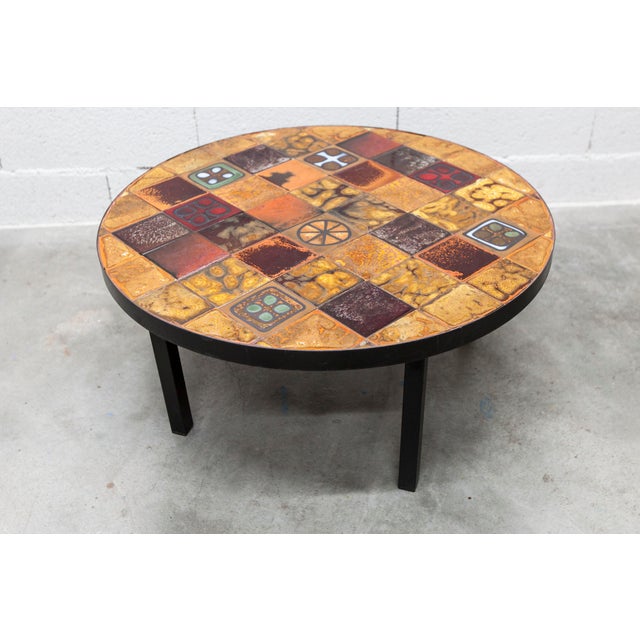 Round ceramic coffee table by Jean Gregorieff. Diameter 77 cm. Ceramic top with no chips or cracks. The colors are vibrant...