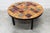 Round ceramic coffee table by Jean Gregorieff. Diameter 77 cm. Ceramic top with no chips or cracks. The colors are vibrant...