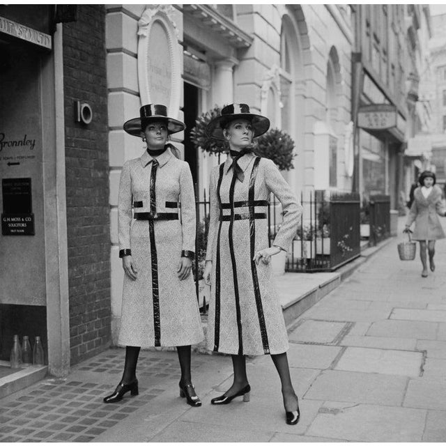 Dior Fashion, 1970 Two female fashion model wearing black and white wool coats and snakeskin poncho hats by Jorn Langberg...