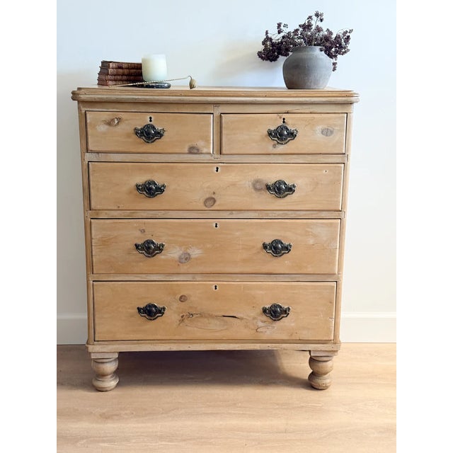 A beautiful pale English pine dresser featuring a two over three drawer configuration. Original brass hardware.