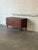 This storage piece features a clean silhouette elevated by tapered legs. The front is defined by a balanced arrangement of...