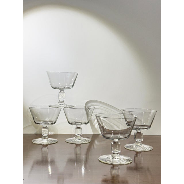 A set of five 1950s coupe glasses, their clear glass bowls set on a distinctive square-cut stem - a graphic, architectural...