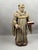 A polychrome carved oak statue from the 18th century depicting Saint Dominic, dressed in a flowing monastic habit. The...
