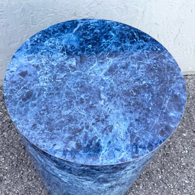 Striking Postmodern cylindrical pedestal featuring a dramatic faux blue marble finish with rich navy, cobalt, gray, and...