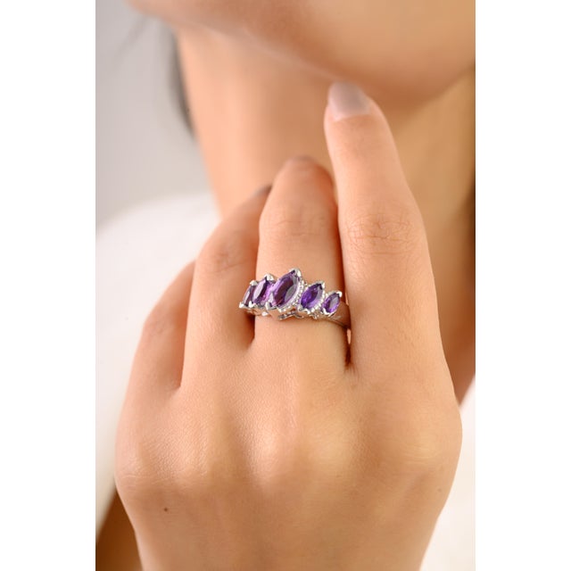 Elegant and timeless, this Five-Stone Marquise Cut Amethyst Ring is crafted in solid 925 sterling silver. It features five...