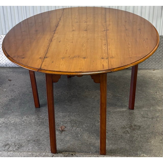 Beautiful English style gateleg table by Wright table company. Features a yew wood top with drop leaves, square legs and...