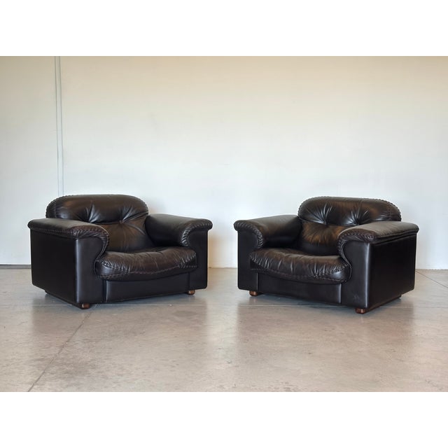 Pair of dark brown leather armchairs, DS 101 model produced by the Swiss company De Sede in the 70s, the peculiarity of...