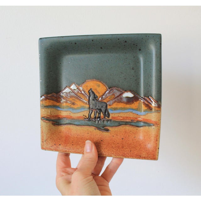 Vintage studio art pottery howling wolf trinket tray. Signed by artist on back. Minor age wear. No chips or cracks.