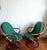 Pair of vintage rattan swivel shell chairs, circa 1970. Rattan and strap frame, swiveling on round legs. Cushions and...