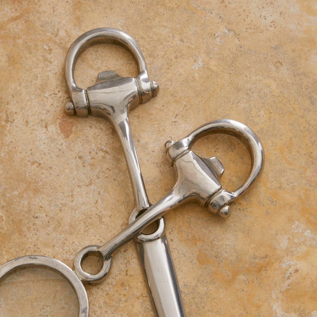 An Italian equestrian desk set from the 1980s, comprising a silver-plated letter opener and a magnifying glass that...