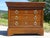Beautiful chest of drawers in a honey-gold color, with four drawers, one of which is curved. Gilt bronze handles and...