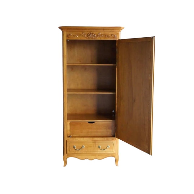 This elegant Country French armoire features a full-length mirrored door framed in beautifully carved solid wood with...