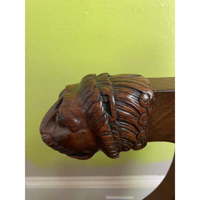 The early 19th century mahogany desk chair with lions head arms and turned legs was made in Paris circa 1820