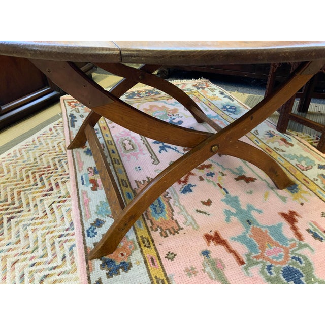 Late 19th century English antique folding coach table. Low oval table top shape, the legs have a yoke design. Beautiful...