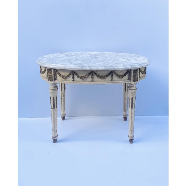 A relatively small oval Italian marble cocktail table, in the Neoclassical design style, circa mid-20th century, Italy....