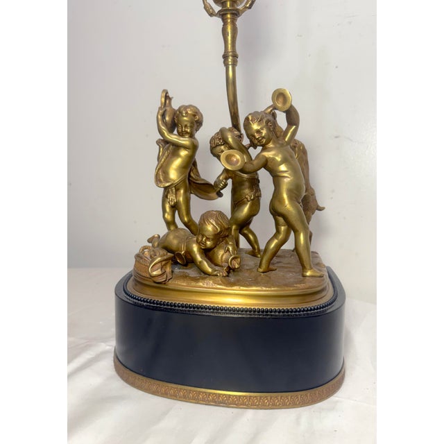 The Antique Claude Michel Clodion, Sevres gilt bronze cherub grouping table lamp statue is a stunning piece of collectible...