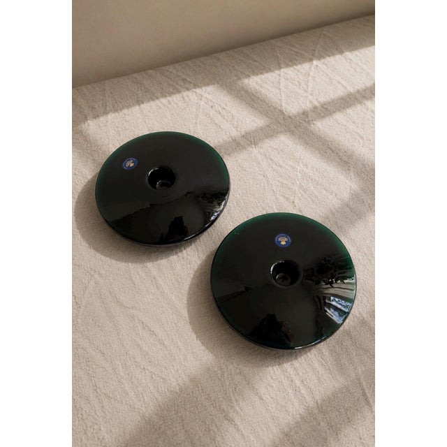 A striking pair of Royal Copenhagen dark green art glass candlesticks designed by renowned Danish glass designer Per...