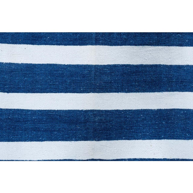 This 1960s Indian Dhurrie runner is a striking example of mid-century flatweave design, where traditional craftsmanship...
