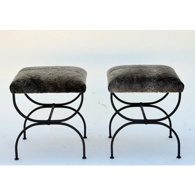 Pair of ‘Strapontin’ wrought iron and fur stools. Also available in C. O. M. (1 yard for both stools) or C. O. L. (2 × 4...