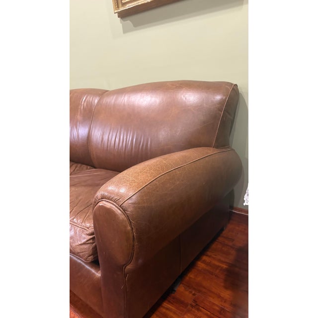Bought from Pottery Barn in early 1990s . This is the classic Manhattan 1930s style leather club sofa with a pullout...