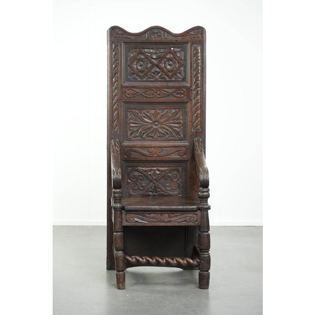 This unique 18th-century English Wainscott chair made of oak features a high back, dark warm colors, and impressive...