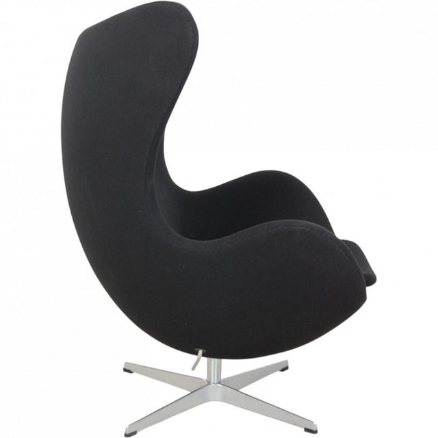 Arne Jacobsen Egg chair upholstered in original black fabric, and with a base of brushed aluminium. The chair is from 2006...