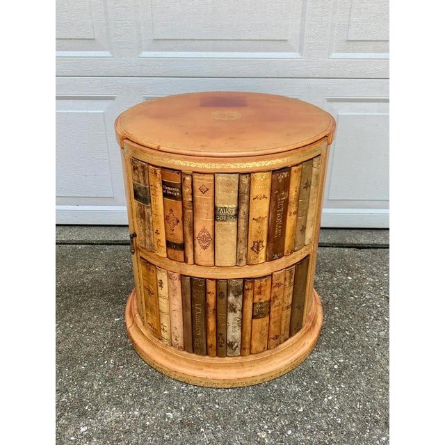A gorgeous trompe l'oeil faux books embossed leather side table with storage Circa 1980s Measures: 19.13"W x 19.13"D x...