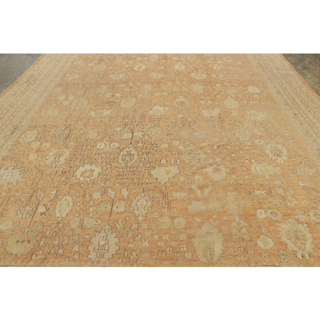 Hand-knotted in wool, this 12x18 oversized antique Ghiordes rug is a remarkable example of Anatolian craftsmanship from...