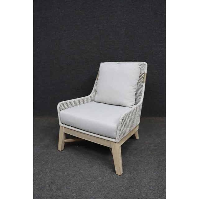 Contemporary club chair by Essentials for Living featuring a handwoven rope frame in a soft neutral tone with a natural...