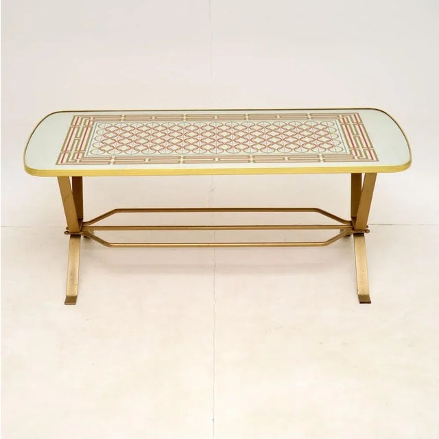 A stylish and interesting vintage coffee table, made in England and dating from the 1970’s. This has a mirrored top with...