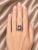 Elegant 14K white gold floral spiral ring featuring 22 brilliant round diamonds totaling 0.7 carats and 8 natural round...