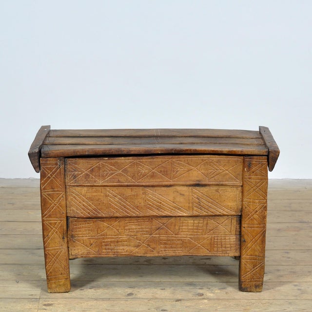 Wooden chest from Romania, dating to around 1900. This characterful piece is handcrafted and richly adorned with...