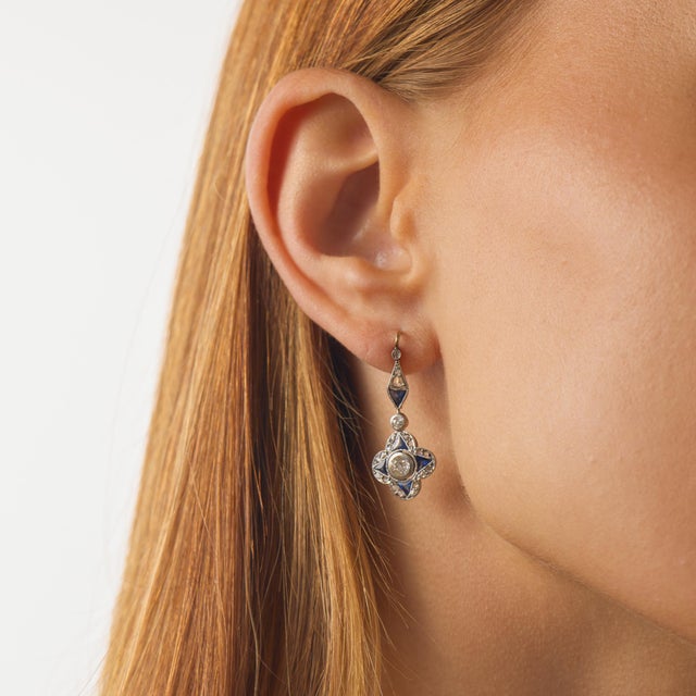These authentic Edwardian drop earrings showcase a refined combination of antique diamonds and vivid sapphire accents,...