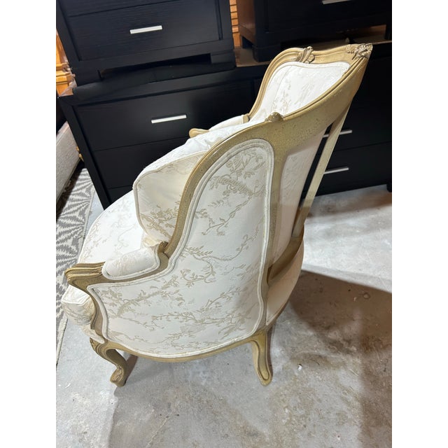Perfectly lovely for your chateau. This Betgere chair produced by Baker in a Fruitwood finish, hand carved frame, spring...