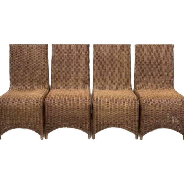 Set of four substantial sculptural Hollywood Regency Trompe L'Oeil draped wicker woven rattan ghost chairs with arms. This...