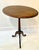Oak tilt top table with turned pedestal and exaggerated, arched legs. Beveled edge on top. Tilt top with metal latch....