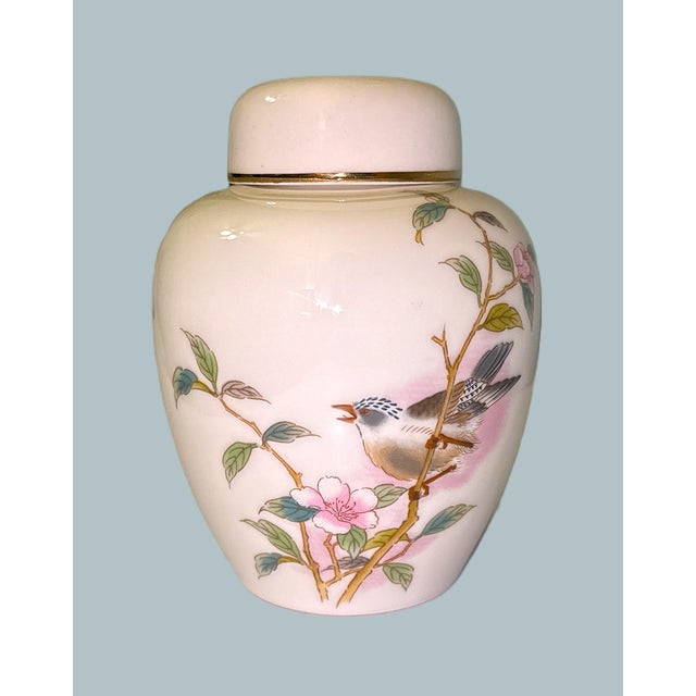 Lovely ginger jar in a glossy creamy white finish with an Asian floral and bird decoration in a mixture of pink, green,...
