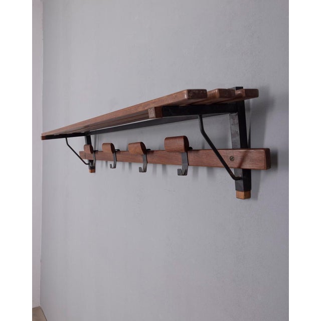 Wall-mounted coat rack with hat rack, with black metal and walnut wood structure, Italian design, 1960s.