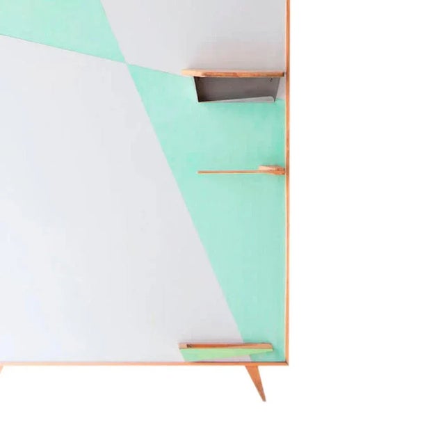 Rack – wall shelf made of Formica and oak, with different accessories.