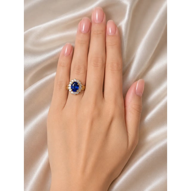Stunning Estate 14K yellow gold engagement ring featuring a 2 carat oval natural sapphire accented by 0.9 carats of...