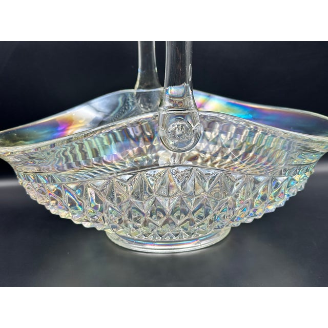 A striking, large‑scale iridescent pressed‑glass centerpiece basket featuring deep diamond‑point faceting, a starburst...