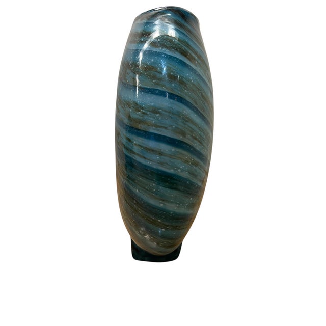 Elevate your space with this stunning, heavy hand-blown art glass vase. The piece boasts a beautiful rounded, spherical...