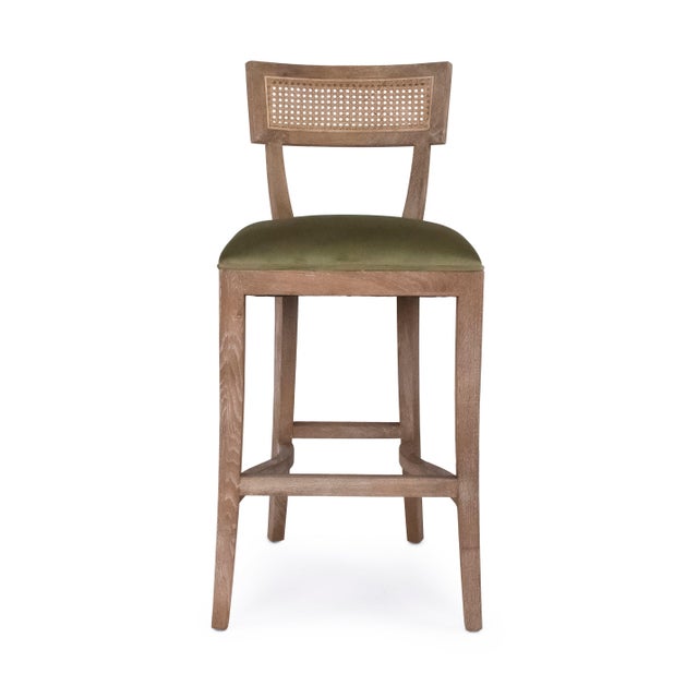 The Carvell Cane Back Bar Stool from Zentique in olive green velvet offers a bold twist on the klismos-inspired...