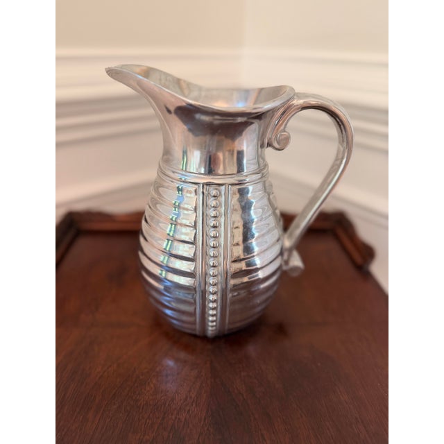 Add classic charm to your bar cart or dining table with this vintage Wilton Armetale “Flutes & Pearls” pitcher. Crafted in...