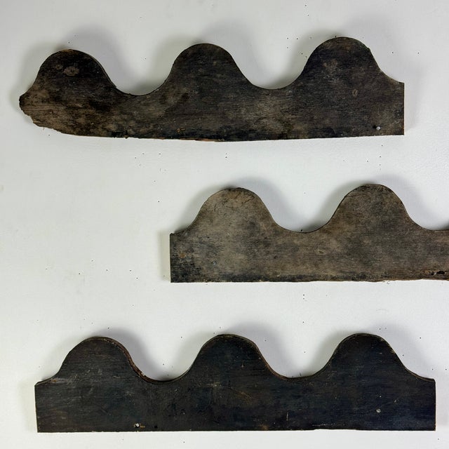 A unique set of 4 architectural salvaged wood elements with wave design, with original paint. We think these make a...