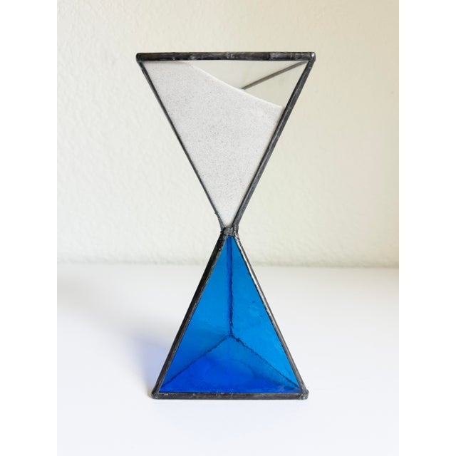 A wonderful brutalist-style hourglass, handmade circa 1970s. Features two triangular-shaped pyramids with a mix of clear...