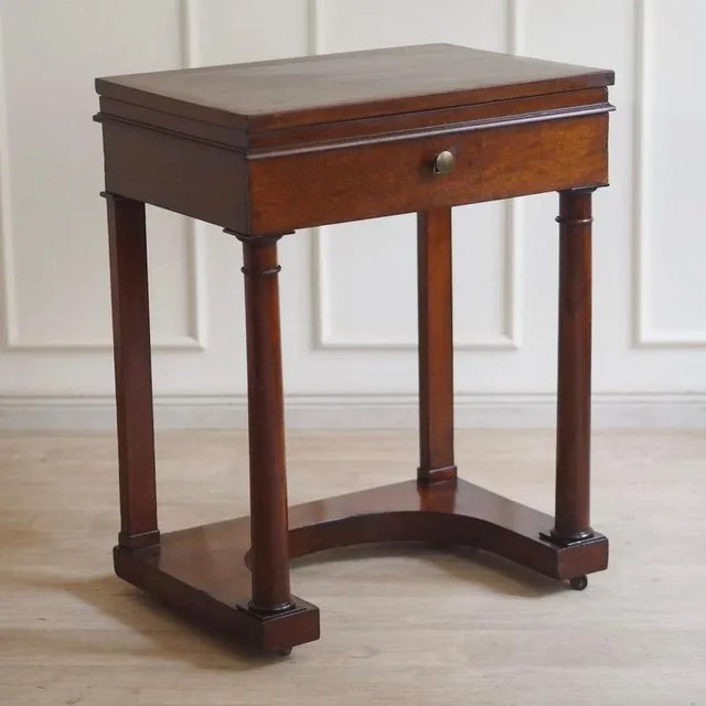 An elegant Biedermeier table from around 1850 with a hinged mirror and divided drawer. The interior is also lined with...