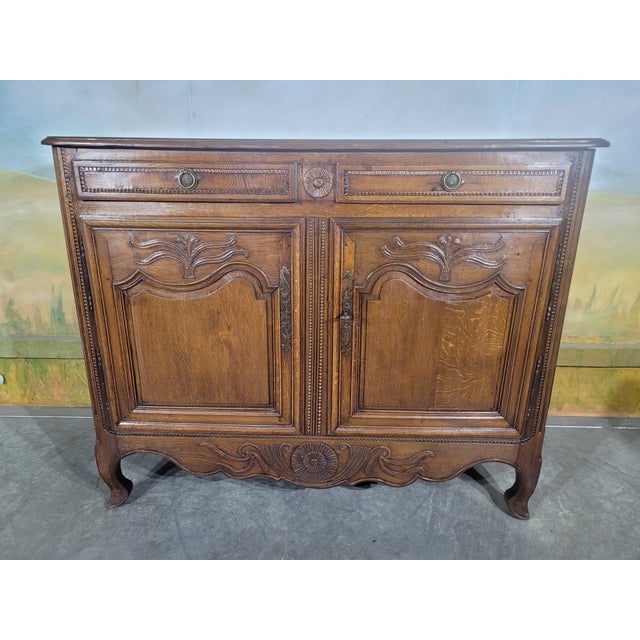 Low two-door carved wood buffet, Louis XV style, 18th century An elegant low buffet opening with two molded and carved...