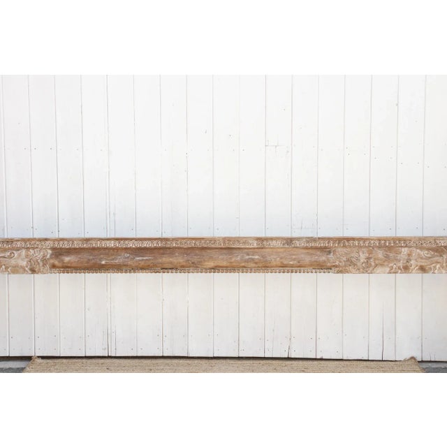 An architectural gem from India, this robust antique carved beam is hand carved from teak wood and is adorned with...